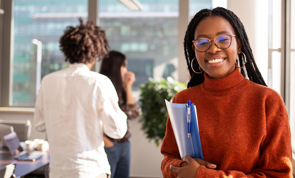 Smiling female intern in an office setting